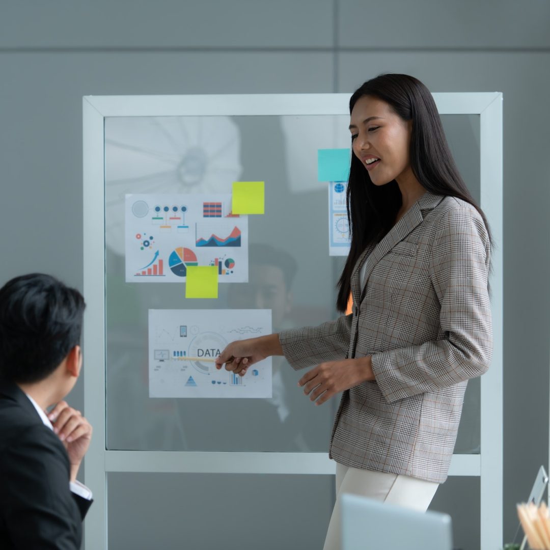 A group of young Asian entrepreneurs. Meeting to review stock investment data in a meeting room