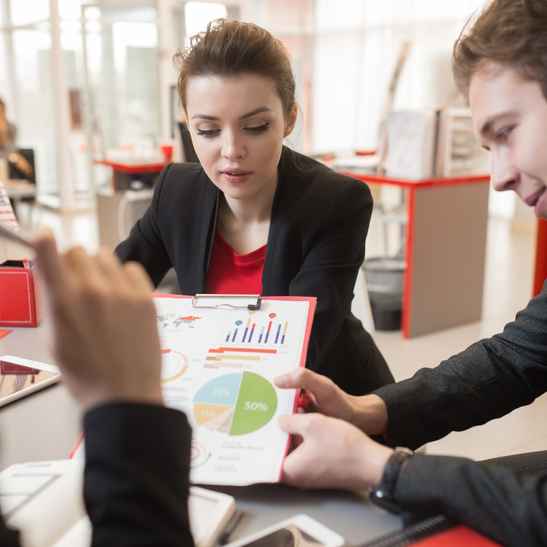 Group of People Discussing Marketing Report