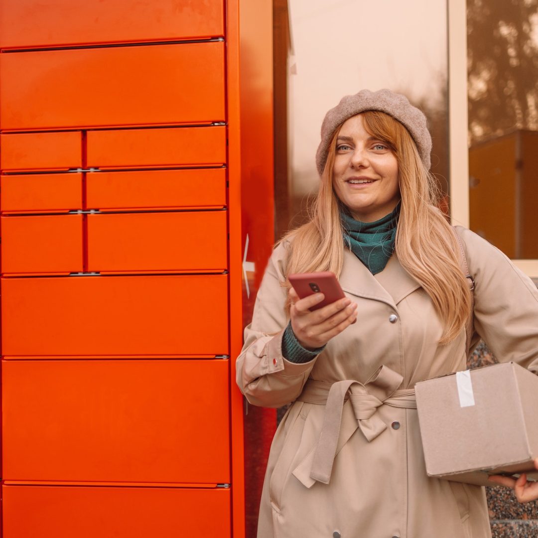 Pickup parcel. Young caucasian woman using automated self service post terminal machine or locker